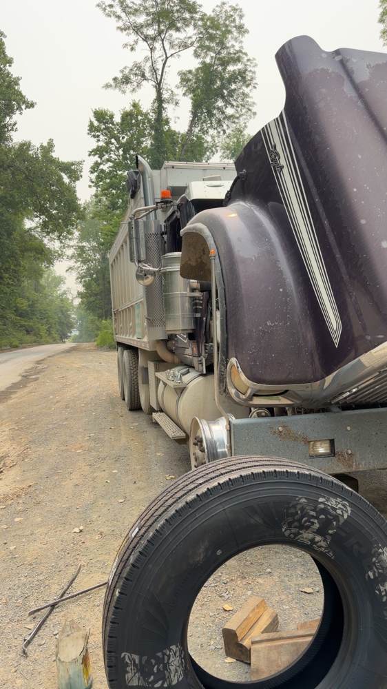 Spare tire swapped onto a dump truck roadside